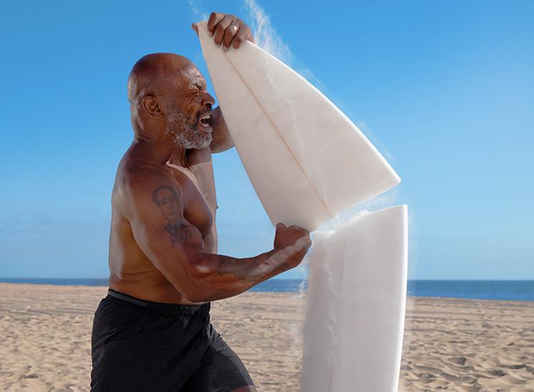 Mike Tyson punches a surfboard