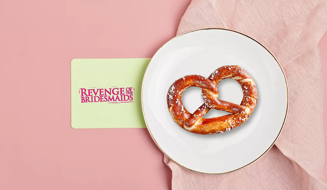 Revenge of the Braidesmaid branding next to a pretzel