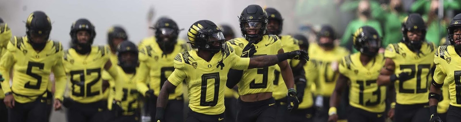 Oregon football players take the field