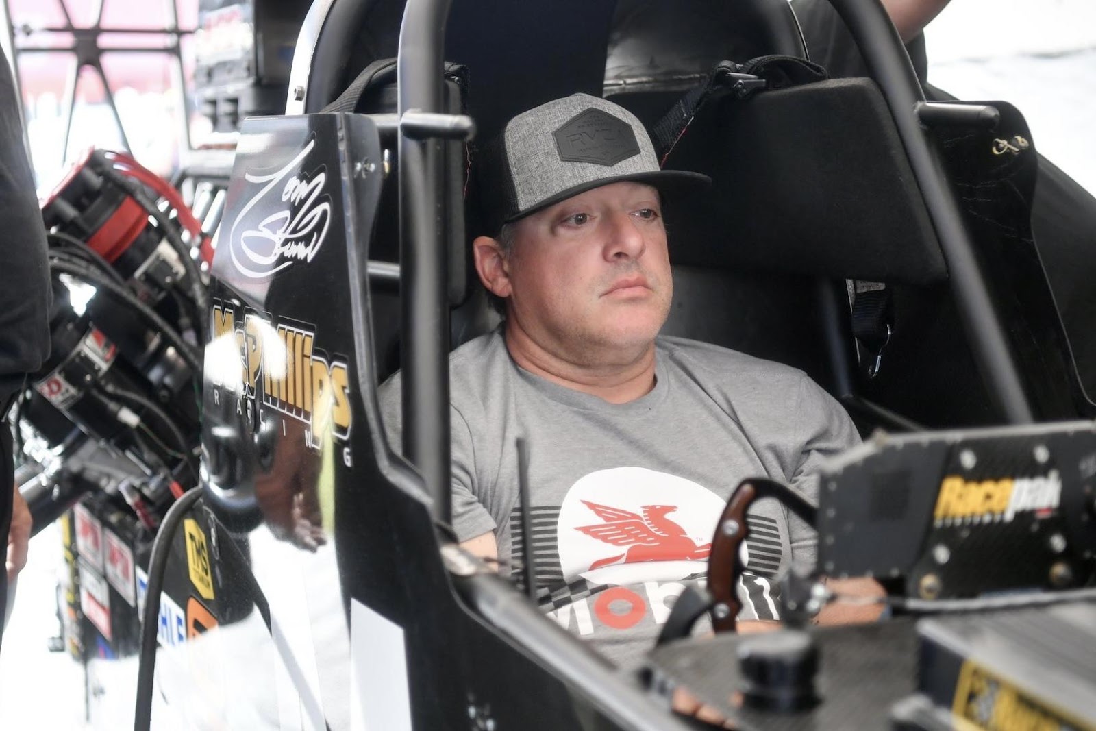 Tony Stewart sitting in the cockpit of a Top Alcohol Dragster during 2023 preseason testing.