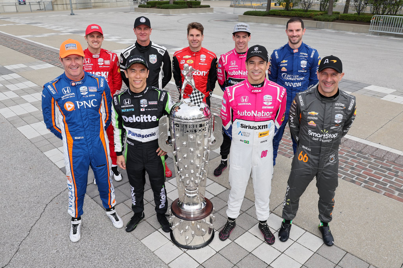 Previous champions of the Indy 500 standing around the Borg-Warner trophy from left to right: Scott Dixon, Marcus Ericsson, Takuma Sato, Ryan Hunter-Reay, Will Power, Simon Pagenaud, Hélio Castroneves, Alexander Rossi, and Tony Kanaan.