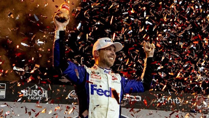 Denny Hamlin celebrates in a shower of confetti after winning the 2022 Coca-Cola 600.