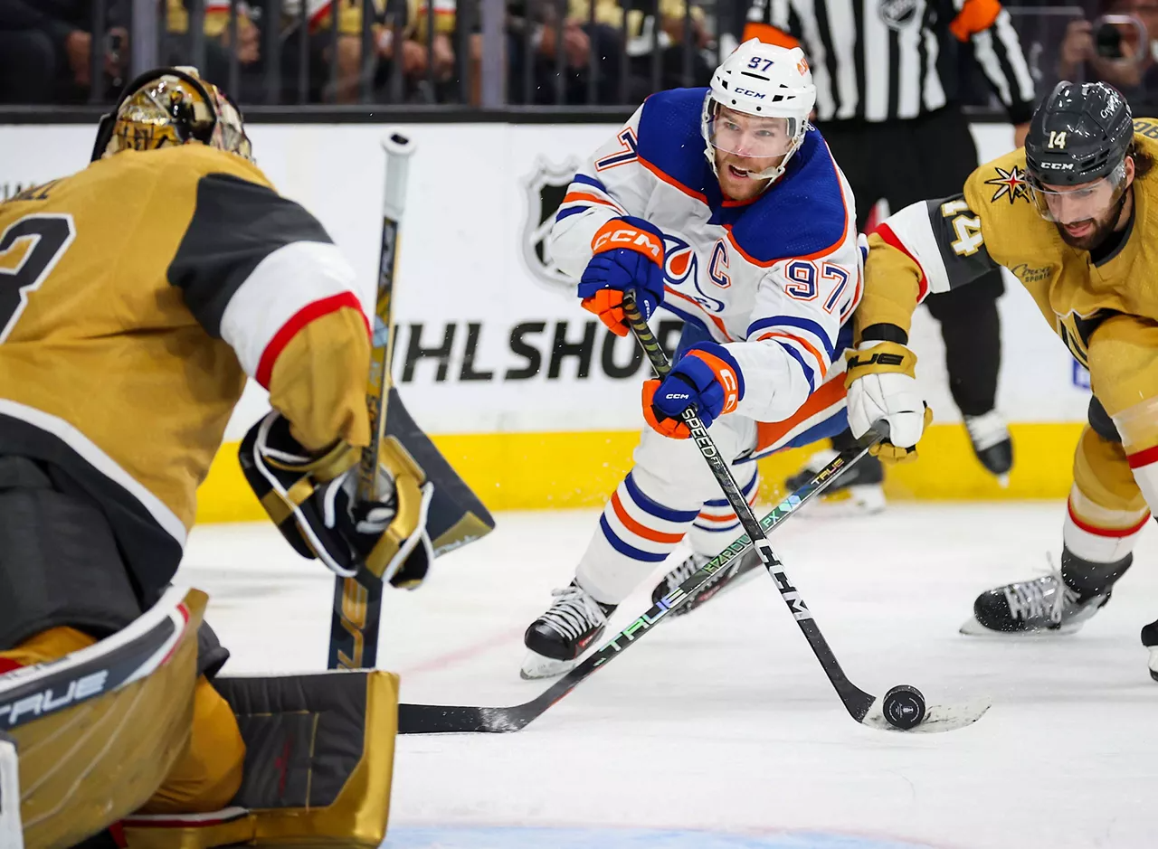 Connor McDavid shooting the puck at the goalie for Vegas